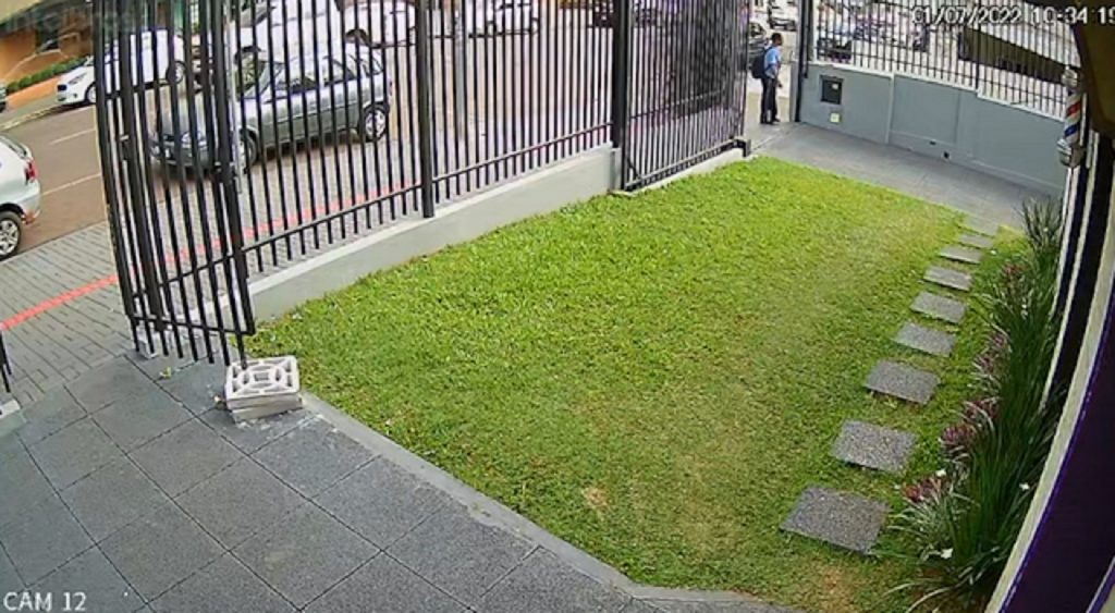 Câmera flagra mulher pegando celular que foi esquecido em mureta
