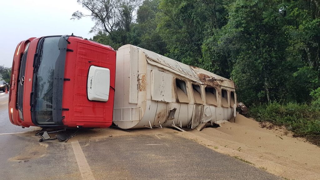 Carreta carregada com grãos tomba na BR-277 após condutor sofrer mal súbito