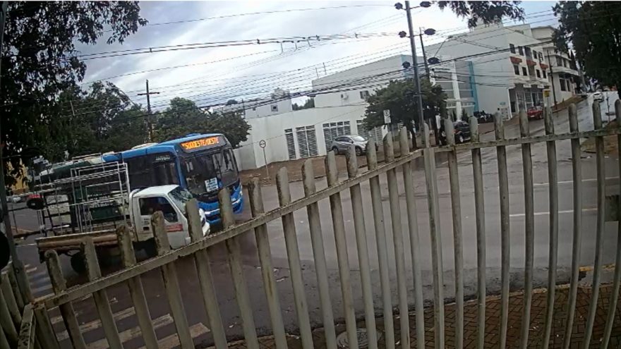 Câmera flagra colisão entre ônibus e caminhão, que é arremessado contra portão de imóvel