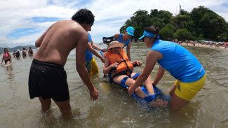 Praia Acessível permite a pessoas com deficiência tomarem banho de mar com segurança