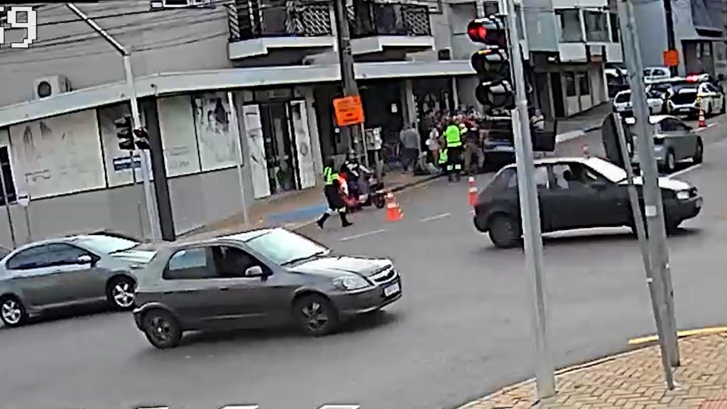 Imagem flagra populares tombando veículo para resgatar vítima após atropelamento na Rua São Paulo Imagem flagra populares tombando veículo para resgatar vítima após atropelamento na Rua São Paulo