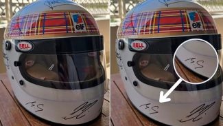 Michael Schumacher assina capacete que será leiloado em ação beneficente promovida por Jackie Stewart