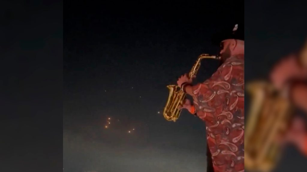 “Kenny G do Apocalipse”: Saxofonista viraliza ao tocar em festa enquanto mísseis cruzam o céu rumo a Israel “Kenny G do Apocalipse”: Saxofonista viraliza ao tocar em festa enquanto mísseis cruzam o céu rumo a Israel