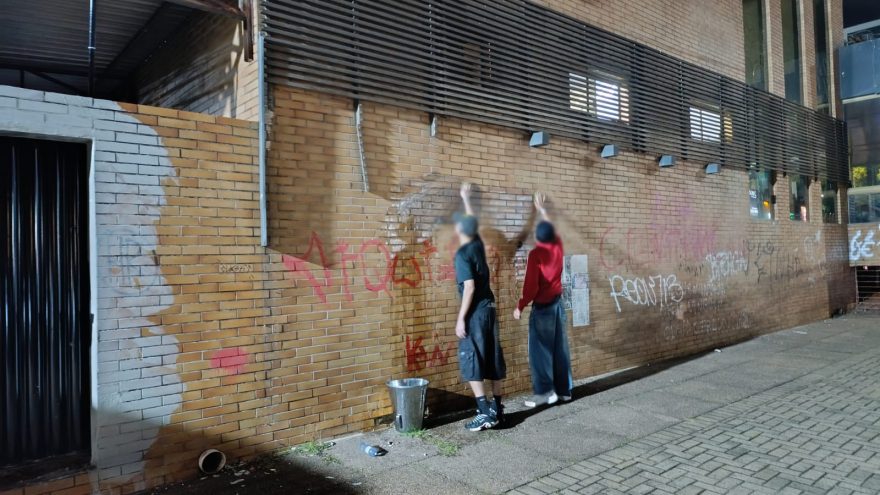 Do pincel ao balde com sabão: após abordagem da GM, dupla “se oferece” para lavar o muro pichado