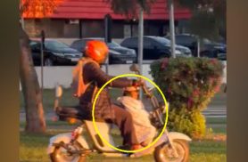 Mulher é flagrada transportando criança de forma inadequada em scooter elétrica